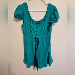 Green shirt with black tie.